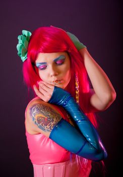 Girl with pink hair and candy lips, studio shot 