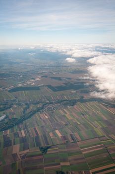Aerial view of Austria above cloudscape and fields