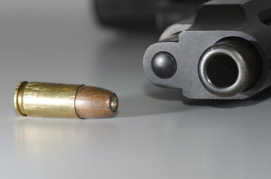 closeup of a bullet and gun barrel