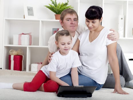 family are working together for a laptop at home