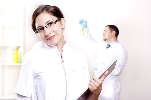 portrait of doctor, holds a tablet in the office