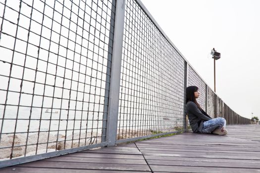 Asian sad woman on floor