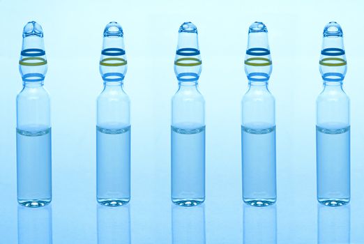 Five ampules with liquid medicine in blue colours