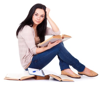 Charming young woman with books sitting on white background
