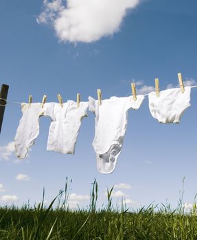 Baby Clothing on a clothesline towards blue sky