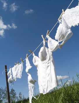 Female underwear on a clothesline towards blue sky