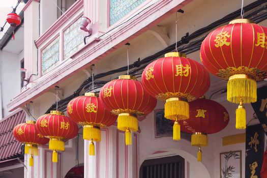 Chinese New Year Red Lanterns with Chinese Text Wishing Good Fortune Hanging on Historic Peranakan Buildings Exterior