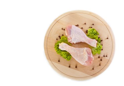 Fresh raw chicken legs with green salad, clipping path included 