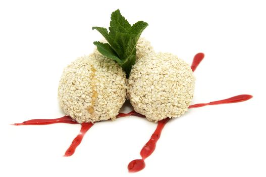 balls of ice cream with sesame seeds on a white background