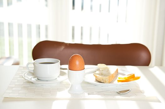 White bread, coffee and eggs for breafast ind the sunlight