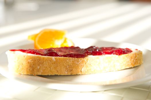 A pice of bread with jam in the morning