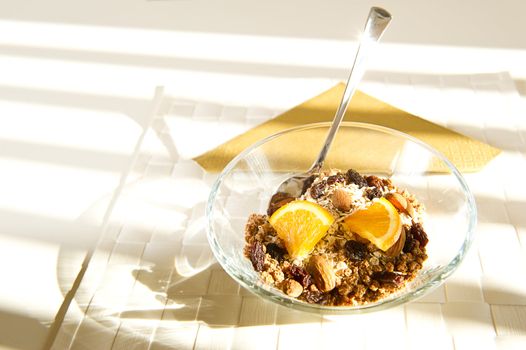 Sunlight through the window hits a bowl of muesli