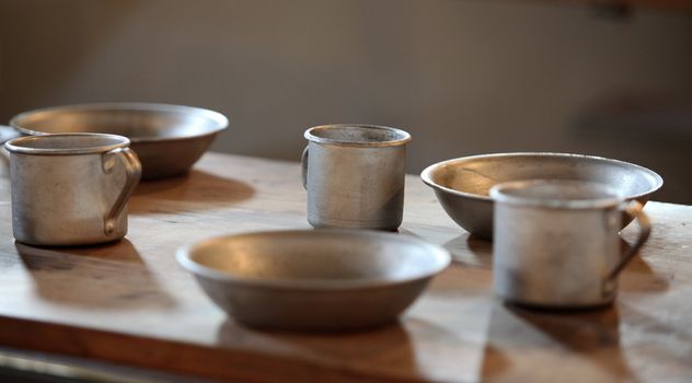 The old aluminum utensils on the table in the chamber