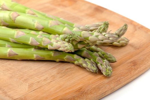 Bunch of fresh asparagus on cutting board