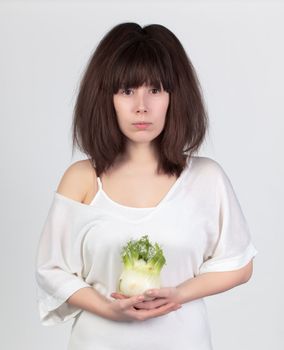 The young beautiful woman with the fresh vegetables, the concept of healthy food