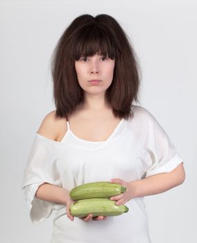 The young beautiful woman with the fresh vegetables, the concept of healthy food