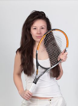 Young woman with tennis racket isolated on white