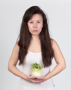 The young beautiful woman with the fresh vegetables, the concept of healthy food