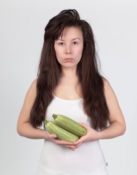 The young beautiful woman with the fresh vegetables, the concept of healthy food