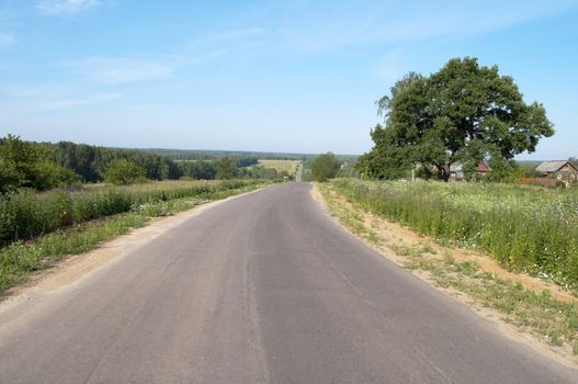 Long empty country road, sunny summer day