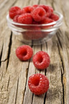 Fresh healthy organic raspberry on wooden background