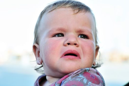 portrait of crying baby girl with sad face