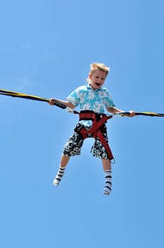 happy little  boy flying over the blue sky