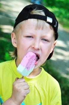 funny little boy eating tasty ice-cream