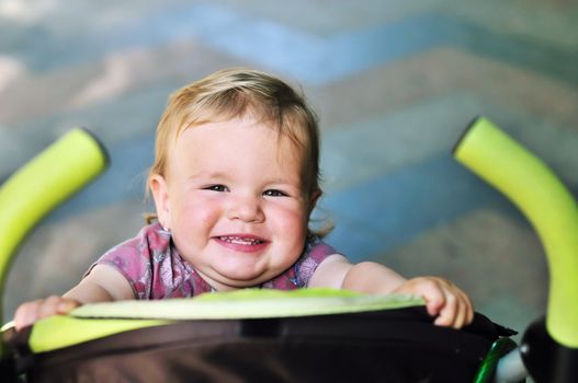 baby girl having fun in the stroller