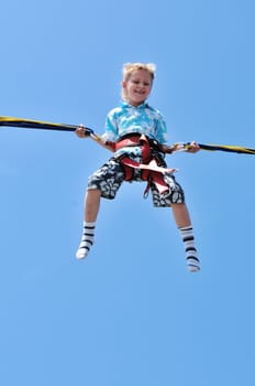 happy little boy flying over the blue sky