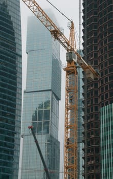 Crane and high-rise buildings at a construction site in Moscow