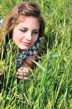 sweet tender girl laying in the high grass