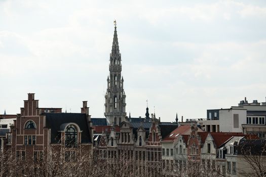 Ornate Brussels Town Hall in Grand Place over old and new buildings
