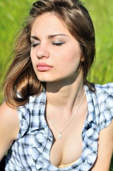 portrait of sweet tender girl relaxing outdoors