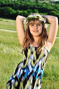 beauty spring teen girl with garland from daisies 