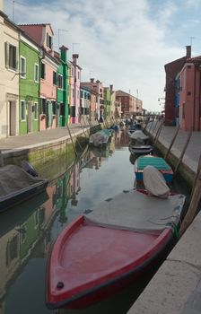 Colorful houses and  boats on the island of Burano near Venice