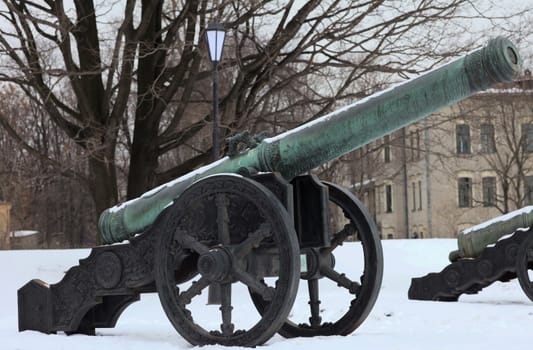 The old medieval bronze cannon on the gun carriage