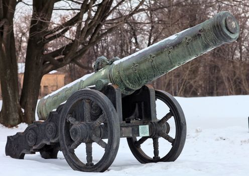 The old medieval bronze cannon on the gun carriage