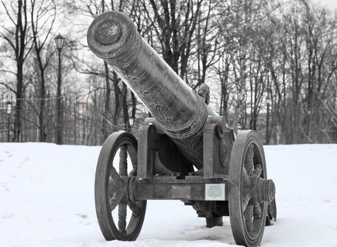 The old medieval bronze cannon on the gun carriage