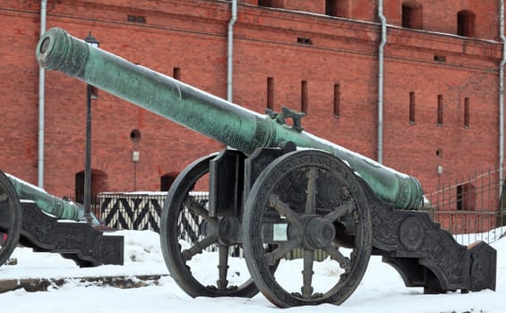 The old medieval bronze cannon on the gun carriage