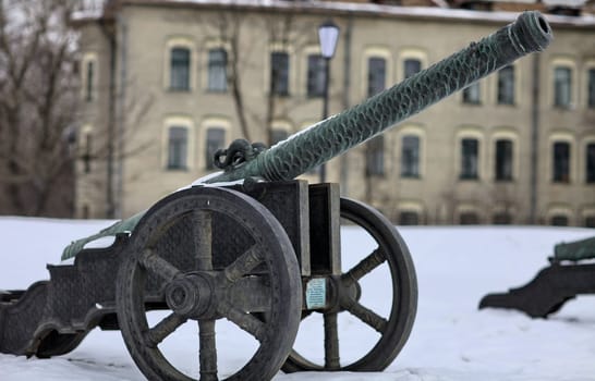 The old medieval bronze cannon on the gun carriage