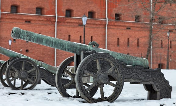 The old medieval bronze cannon on the gun carriage