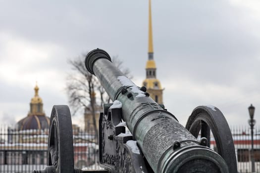 The old medieval bronze cannon on the gun carriage