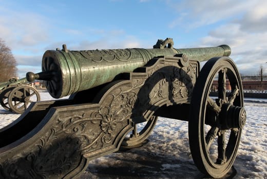 The old medieval bronze cannon on the gun carriage