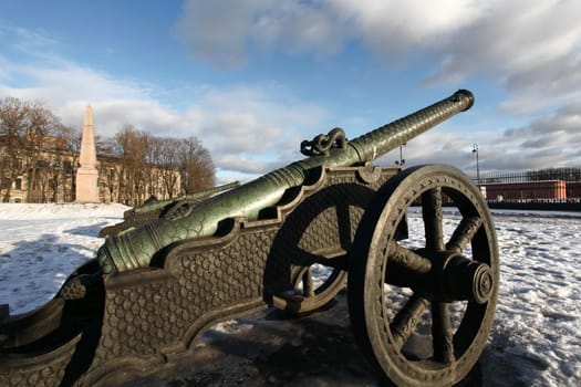 The old medieval bronze cannon on the gun carriage