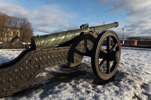 The old medieval bronze cannon on the gun carriage