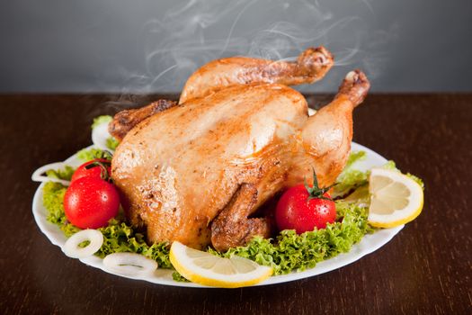 Roast chicken with fresh vegetables, studio shot 