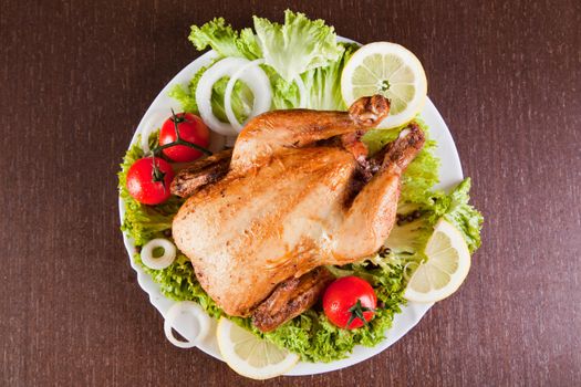 Roast chicken with fresh vegetables, studio shot 