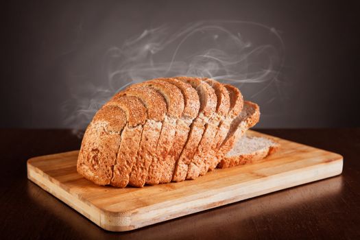 Fresh sliced bread with smoke, studio shot 