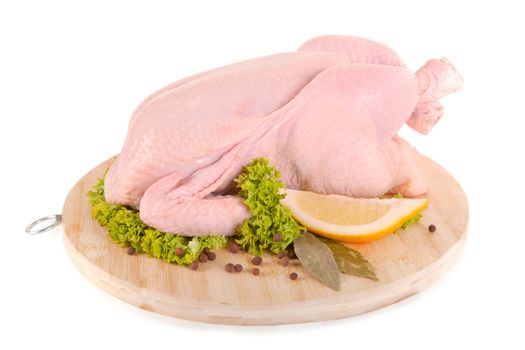 Fresh raw chicken on wooden board, isolated on white background, clipping path included 